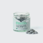Eco natural toothpaste tablets in a plastic-free jar promoting zero waste and oral health benefits