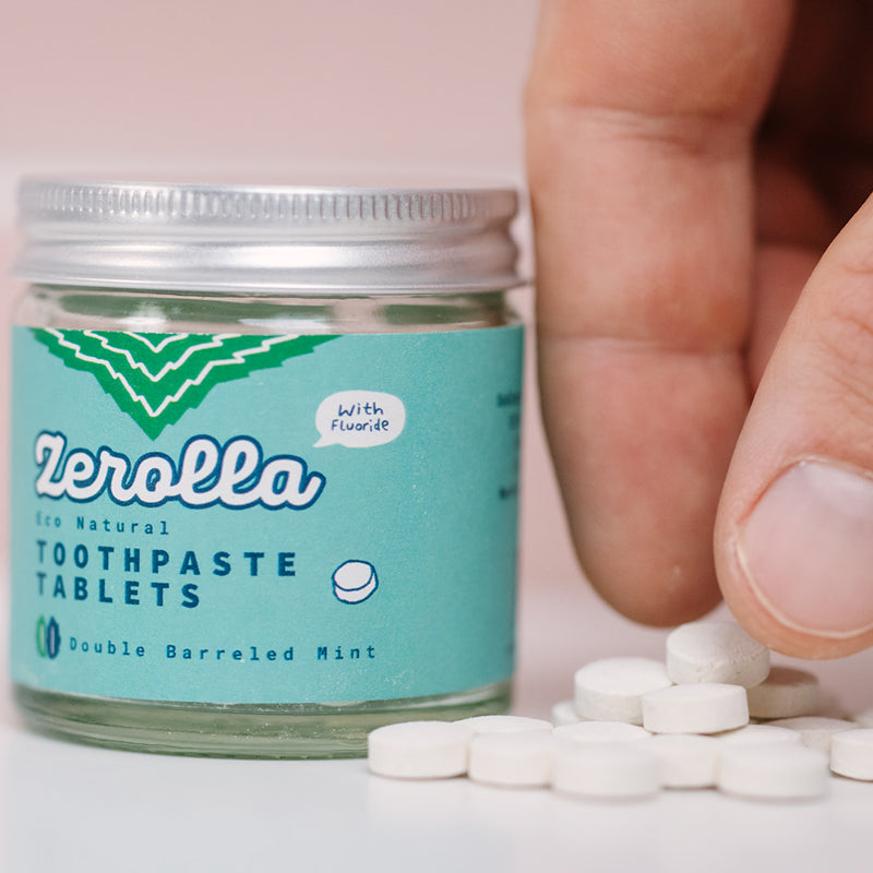 Jar of eco-friendly toothpaste tablets with zero-waste packaging and whitening ingredients